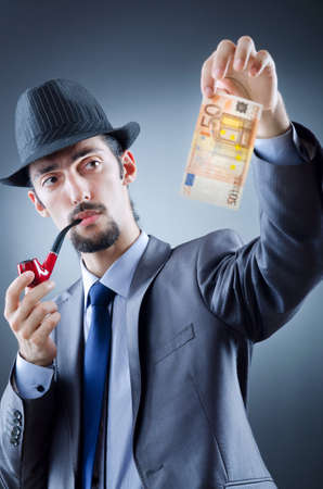 Detective looking at fake moneyの写真素材