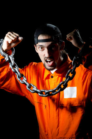 Inmate chained on black backgroundの写真素材