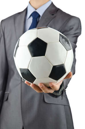 Businessman holding football on whiteの写真素材