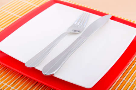 Emtpy plates with utensils on table