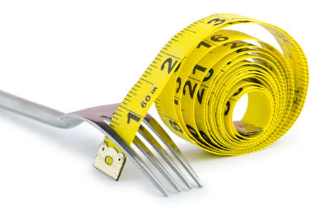 Dieting concept with fork and meterの写真素材