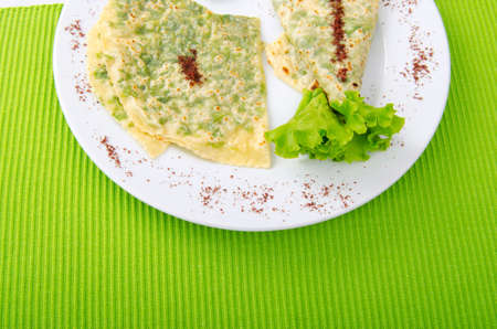 Herb stuffed pancaces in the plateの写真素材
