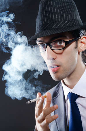 Young man smoking cigaretteの写真素材