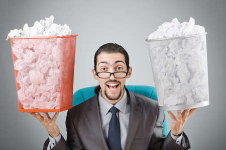 Man with lots of wasted paperの写真素材