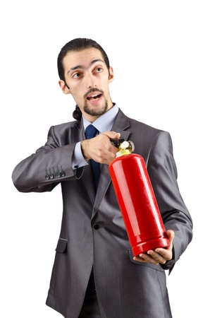 Man with fire extinguisher in firefighting conceptの写真素材