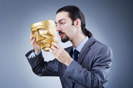 Businessman with mask concealing his identityの写真素材