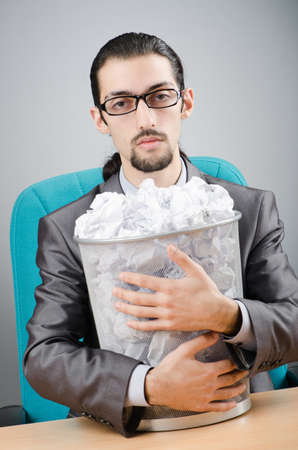 Man with lots of wasted paperの写真素材
