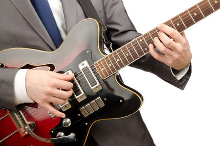 Young guitar player isolated on white