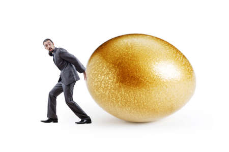 Man and golden egg isolated on whiteの写真素材