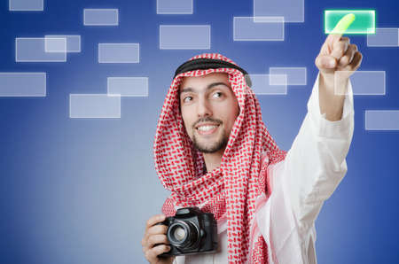 Young arab pressing virtual buttonsの写真素材
