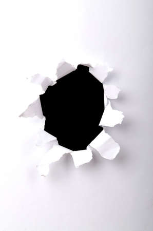 Hole in the white paperの写真素材
