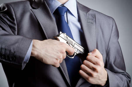Businessman man with hand gunの写真素材