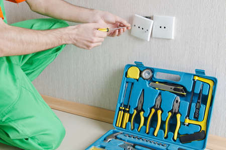 Electrician repairman working in the house