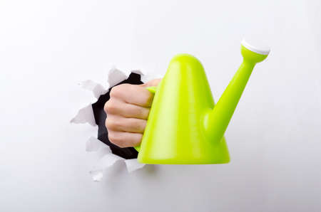 Hand holding through the hole in paperの写真素材