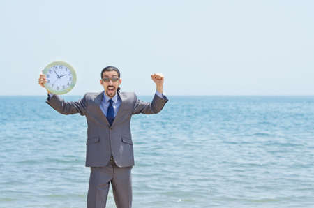 Man with clock on seasideの写真素材