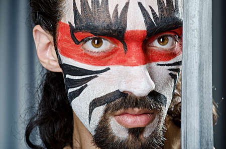 Man with face mask and sword