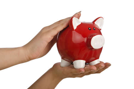 Hand with piggybank on white backgroundの写真素材