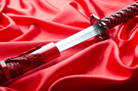 Japanese sword takana on red satin backgroundの写真素材