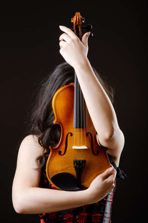 Female violin player against backgroundの写真素材