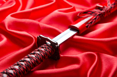 Japanese sword takana on red satin backgroundの写真素材