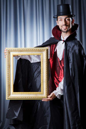 Magician with photoframe in studioの写真素材