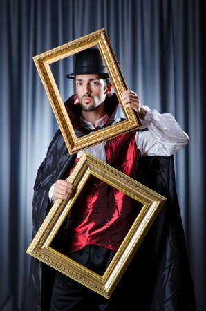 Magician with photoframe in studioの写真素材