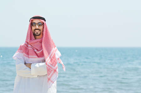 Arab on seaside in traditional clothingの写真素材