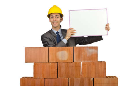 Businessman with bricks on whiteの写真素材