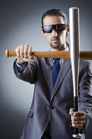 Angry businessman with bat on whiteの写真素材