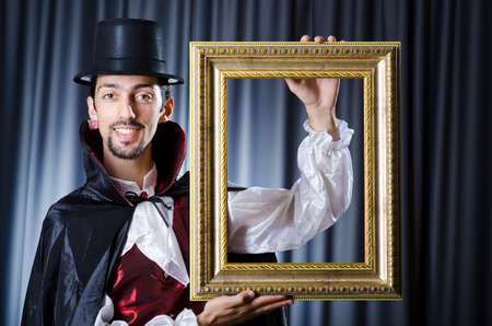 Magician with photoframe in studioの写真素材