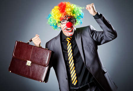 Businessman with clown wig and face paintの写真素材
