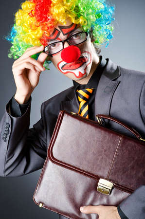Businessman with clown wig and face paintの写真素材