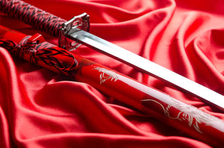 Japanese sword takana on red satin backgroundの写真素材