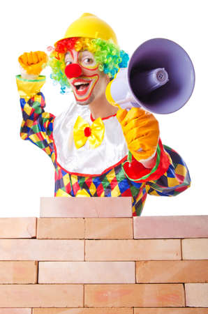 Bad construction concept with clown laying bricksの写真素材