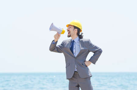 Man wearing helmet speaks with megaphoneの写真素材