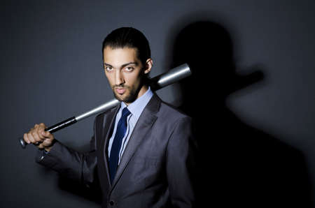 Angry businessman with bat on whiteの写真素材