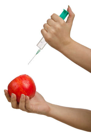 Experiment with apple and syringe on whiteの写真素材