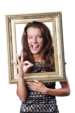 Young woman with picture frame on whiteの写真素材