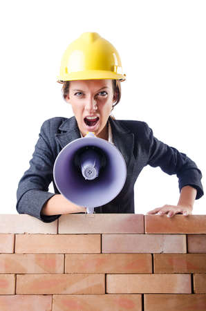 Woman builder with loudspeaker on whiteの写真素材