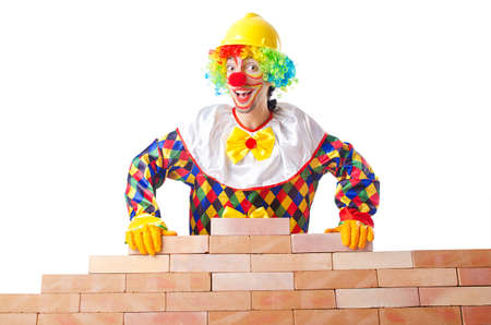 Bad construction concept with clown laying bricks
