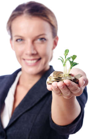 Businesswoman with seedlings and coinsの写真素材