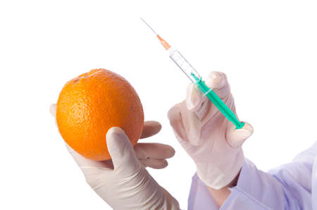 Science experiment with orange and syringeの写真素材