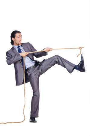 Businessman pulling rope on whiteの写真素材
