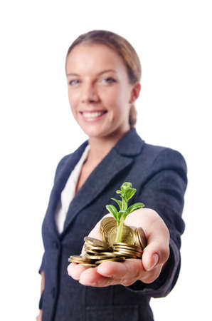 Businesswoman with seedlings and coinsの写真素材