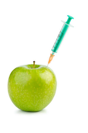 Experiment with apple and syringesの写真素材