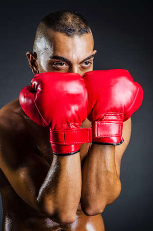 Boxer with red gloves in dark roomの写真素材