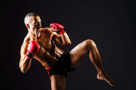 Boxer with red gloves in dark roomの写真素材