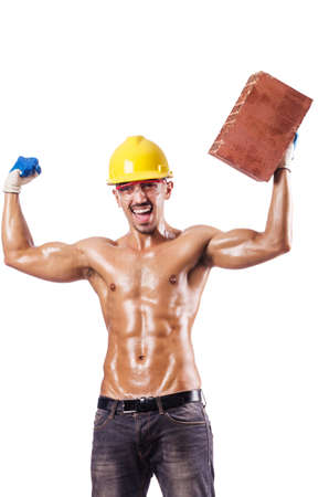 Muscular builder with bricks on whiteの写真素材