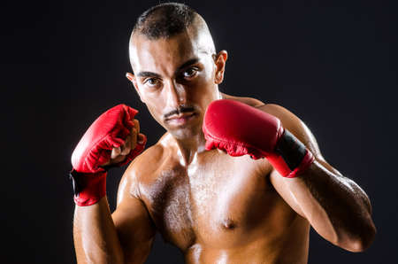 Boxer with red gloves in dark roomの写真素材