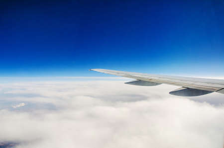 Airplane wing out of windowの写真素材